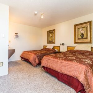 Experience comfort at its finest in room 112 at Motel Big Country Inn, Canada. With two queen-size beds, AC, TV, fridge, microwave